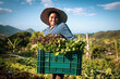 © EZ PHOTOS - Portrait of proud organic farmer woman wearing a hat from a quilombola community harvesting vegetables. Bio food gathering in a sunny day and blue sky.