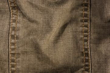 clothing items stonewashed cotton fabric texture with seams, clasps, buttons and rivets, macro