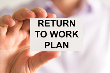 Businessman holding Returning To Work Plan message card