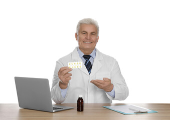 Poster - Professional pharmacist with pills and laptop at table against white background