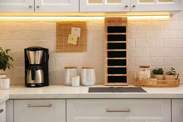 Poster - Stylish kitchen interior with modern coffeemaker on countertop