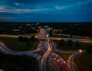 Wall Mural - Long exposure drone shot of eight shaped traffic crossroads in Lexington, Kentucky with distant look of the city downtown.