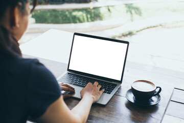 computer mockup image blank screen.hand woman work using laptop with white background for advertising,contact business search information on desk at coffee shop.marketing and creative design