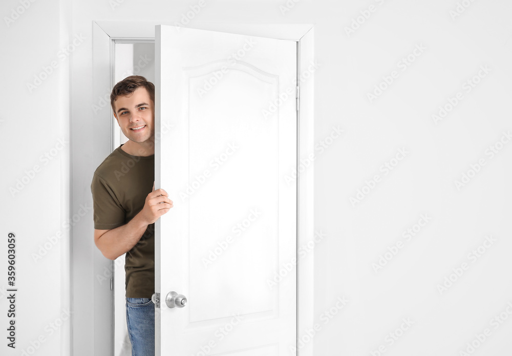 Curious man looking out the door