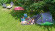 © Iuliia Sokolovska - Aerial top view of campsite from above, mother and daughter having fun, tent and camping equipment under tree, family vacation in camp outdoors concept
