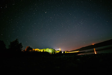 Wall Mural - moon against a bright night starry sky reflected in the sea