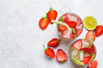 Wall Mural - Detox sassy water with strawberries and lime in glasses, top view. Healthy eating concept.