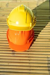 Yellow  and orange  hard safety helmet hat for safety workman as engineer or worker.