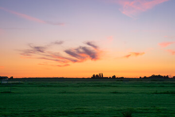 Wall Mural - beautiful pink colored cirrus clouds over the dutch countryside during the period of the longest day