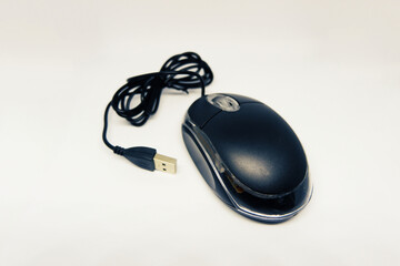 Black laser mouse with USB cable isolated on white background