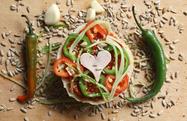 A sandwich with hot peppers and seeds