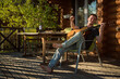 © tarasov_vl - Young man playing guitar and drinking wine alone. Covid-19 quarantine.