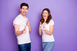 Portrait of positive two people students man woman point you finger decide choose great solution wear white t-shirt denim jeans isolated over violet color background