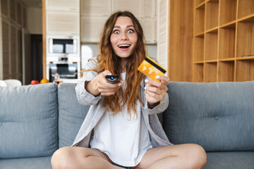 Sticker - Cheerful young woman relaxing on a couch at home