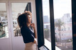 © Wavebreak Media - Young mixed race businesswoman thinking in front of windows