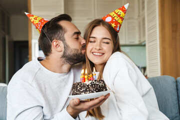 Wall Mural - Cheerful attractive young couple celebrating birthday