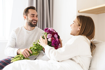 Sticker - Happy man giving his lovely girlfriend bouquet of flowers