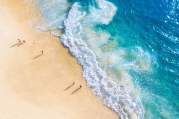 Beach, people and waves. Coast as a background from top view. Blue water background from drone. Summer seascape from air. Nusa Penida island, Indonesia. Travel - image