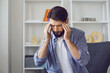 © Studio Romantic - Young man with headache or high blood pressure at home.
