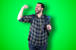 © Carlos Banyuls - Portrait of a cheerful young traveler man showing okay and victory gesture isolated on the chroma background