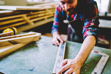 Wall Mural - selective focus on artisan ruler for measuring wooden details on working place, cropped image of mal