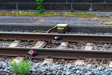 Railroad Tracks Lying On Concrete Sleepers, Filling Large Pieces Of Rock, Visible System On The Axle Counter Detection Unit And Pavement.