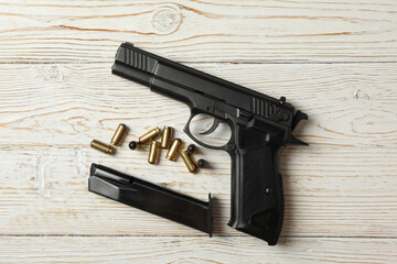 Wall Mural - Pistol, bullets and magazine on wooden background