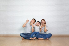 Asian Family Pointing With Finger To Top
