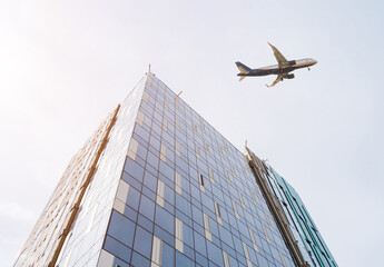 High-rise building under construction and plane