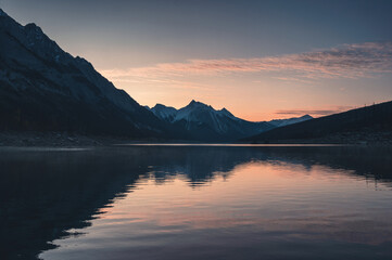 Wall Mural - Sunrise on rocky mountains with colorful sky on Medicine Lake, Jasper national park