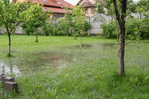 The garden and yard are flooded. Consequences of downpour, flood. Rainy summer, Ukraine, 2020.