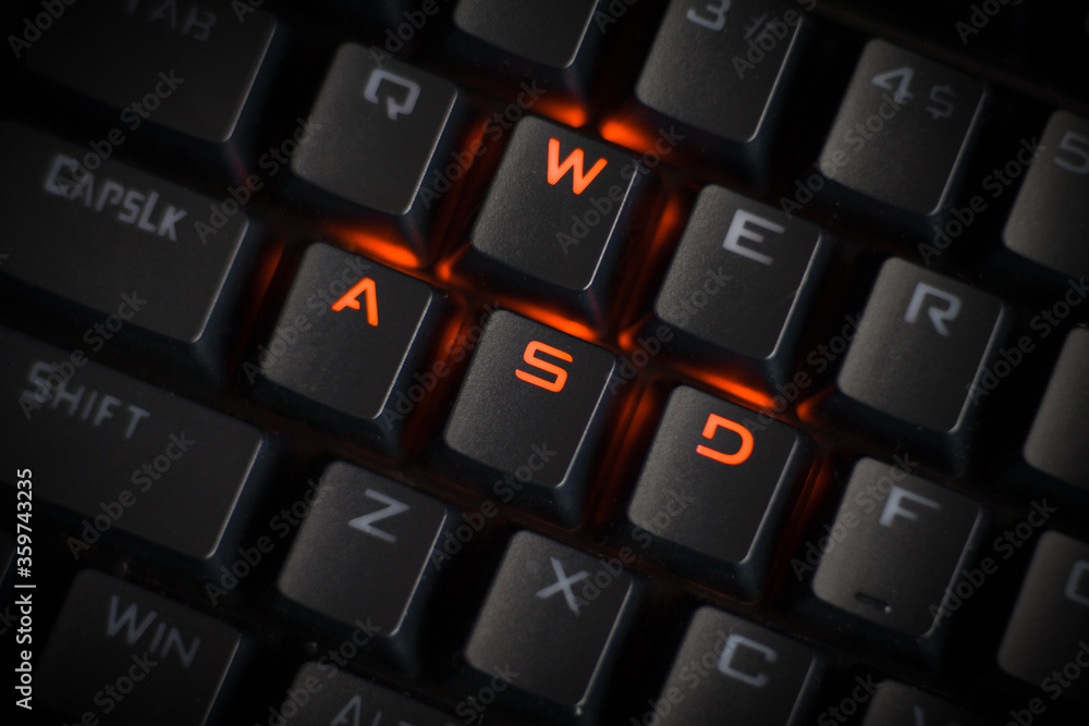 Wasde Keyboard WASD keys light up in orange on RGB mechanical gaming keyboard. WASD ...