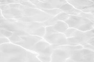 Closeup of desaturated transparent clear calm water surface texture with splashes and bubbles. Trendy abstract nature background. 