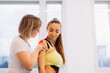 © dsheremeta - Physical therapist placing kinesio tape on woman patient's shoulder and neck
