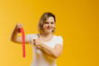 © dsheremeta - A therapist rolling kinesiology tape to demonstrate it on the yellow background. Alternative kinesio tape therapy, healthcare concept