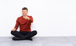 © luismolinero - Young handsome man sitting on the floor points finger at you