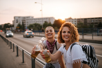 Wall Mural - Close-up image of two party girls making a toast.