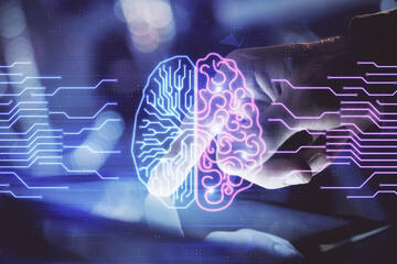 Double exposure of man's hand holding and using a digital device and brain hologram drawing. Data concept.