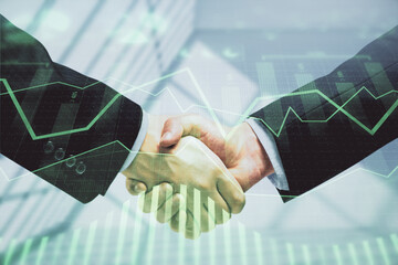 Double exposure of forex graph hologram and handshake of two men. Stock market concept.