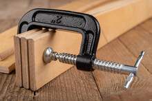 Carpentry Clamp Used For Gluing Wood. Carpentry Accessories In A Home Workshop.
