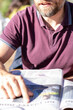 © Em Neems Photography - Man with beard reading newspaper at local outdoor cafe