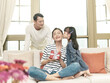 © imtmphoto - little asian girl kissing mother on the cheek after giving a present