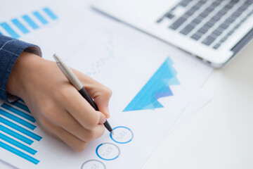 Hand of business man pointing document data graph and chart with pen, marketing and investment, report of statistics profit for financial, economic and growth of finance, management and planning.