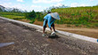 a worker leveling the ground manually