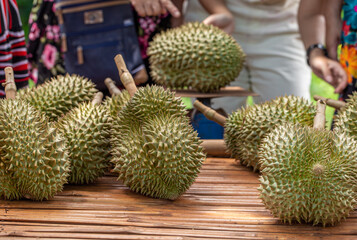 Durian fruit for sale to customers on the table. Durian market in Thailand.