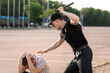 © Pixel-Shot - Aggressive police officer mistreating man outdoors