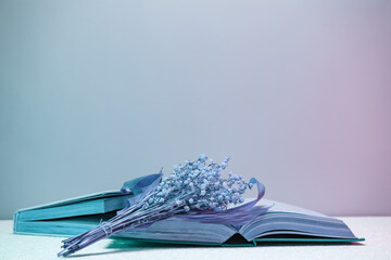 Poster - Close up Beautiful open book and flowers  in neon light. Minimalism retro style concept. 80s. Background pattern for design.