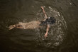 © Milou Dirks - Overhead view of girl swimming in lake