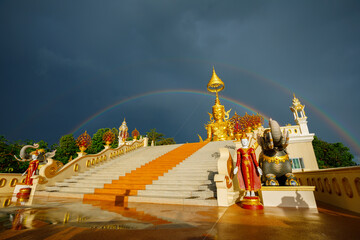 Wall Mural - Golden Buddha with Rainbow in Wat Phrathat Doi Saket Chiangmai City Thailand.