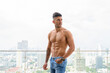 © Ranta Images - Young handsome muscular Persian man shirtless thinking against view the city
